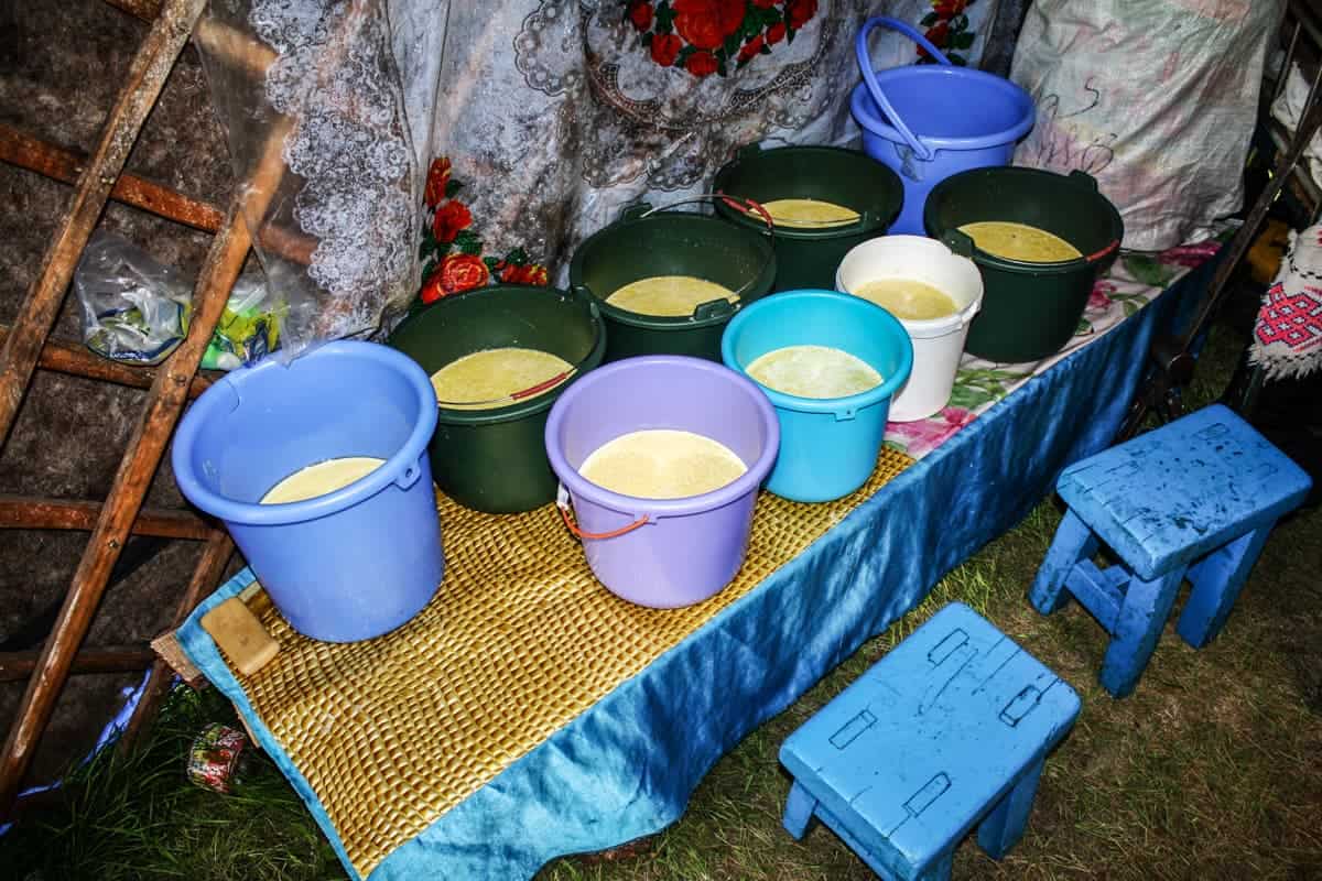 Buckets of fermented mares milk and other dairy products stored inside a Mongolian ger in Mongolia