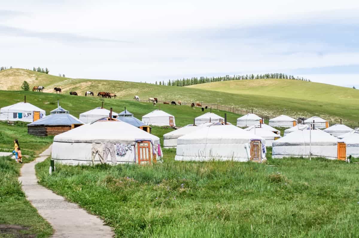 A Mongolian Ger camp on green, rural land where tourists can stay