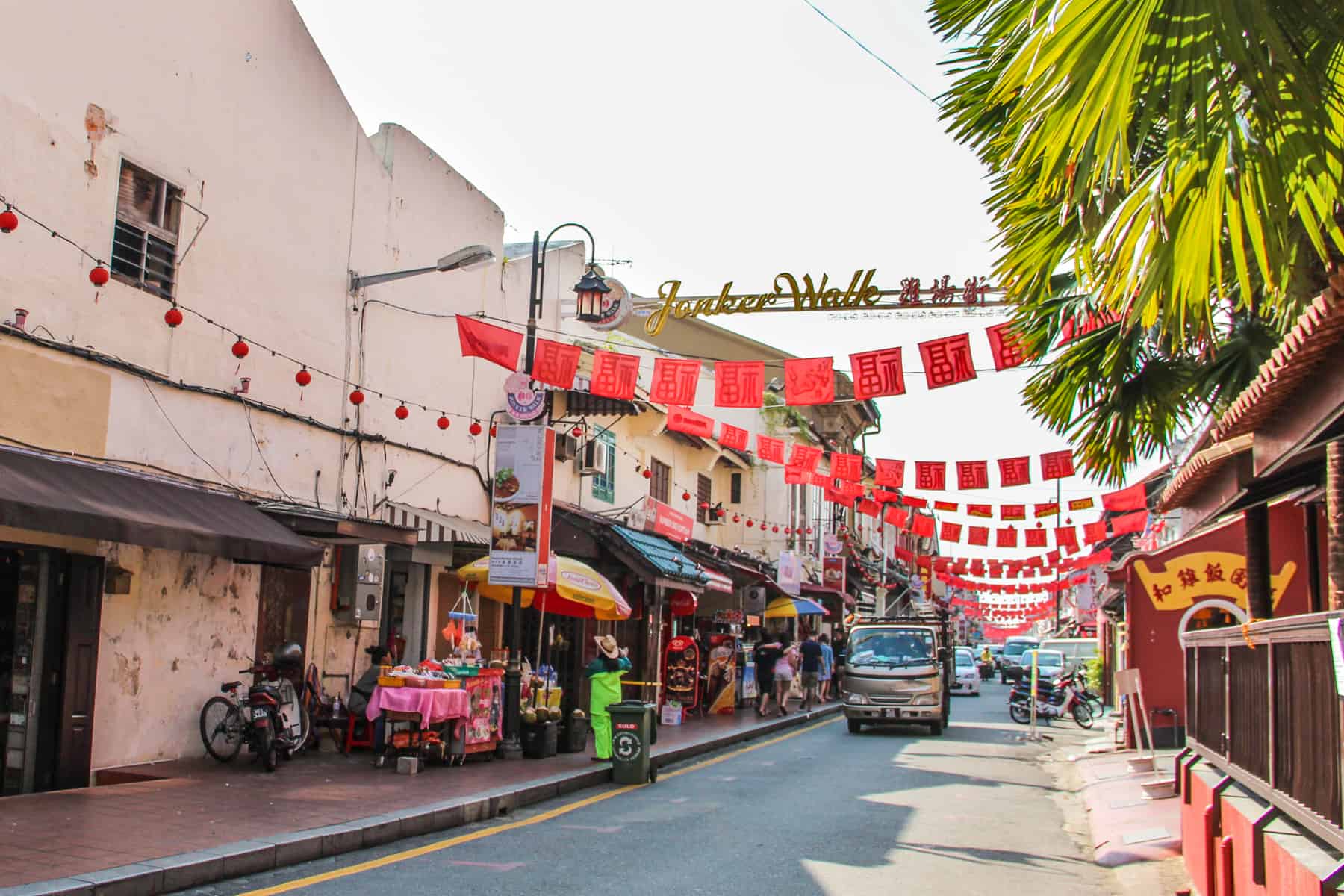 Jonker Street (the centre street of Chinatown) in Melaka, Malaysia marked by red decorative flags with Chinese symbols