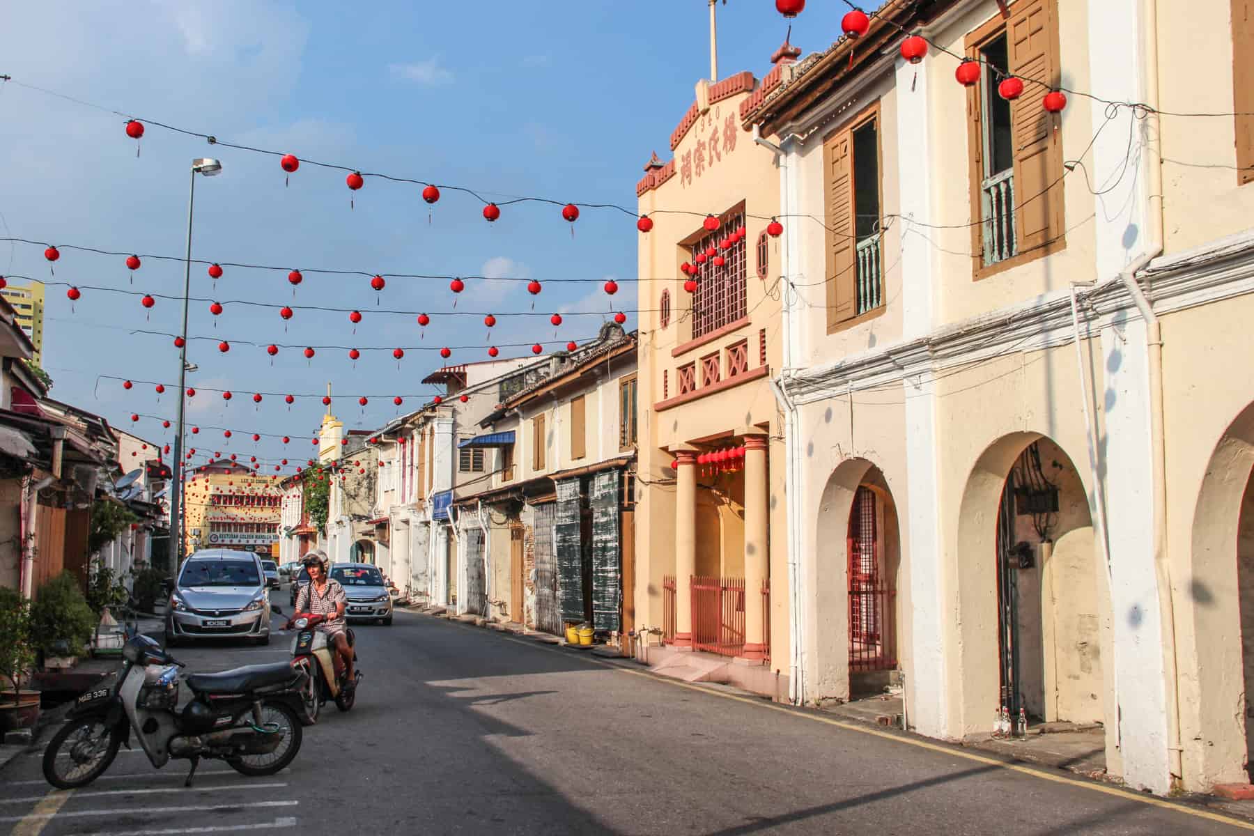 The beige colonial buildings in Melaka, shown in this typical street of beige structures