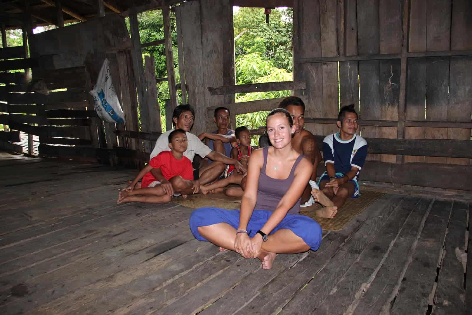 Traveller visiting an Iban Longhouse in Borneo