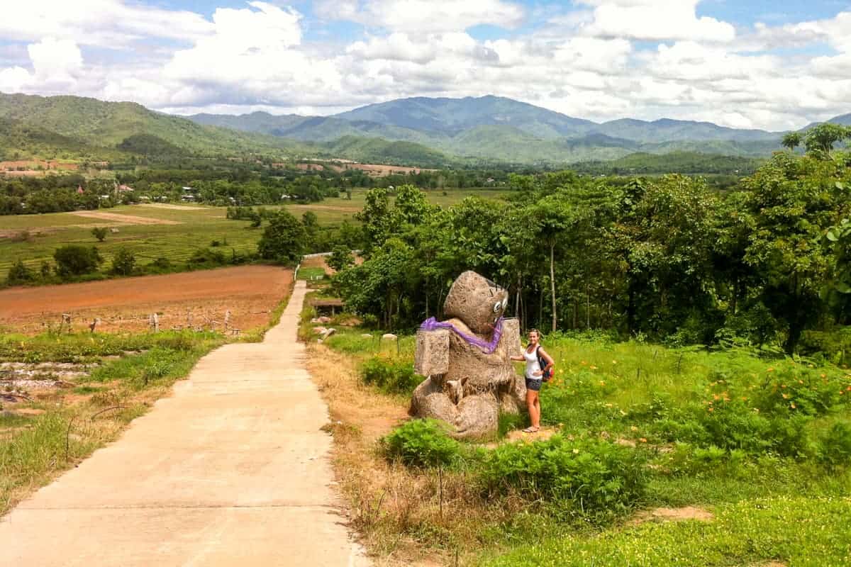 An artwork made of hay on a rural road in the green Pai hills in Thailand