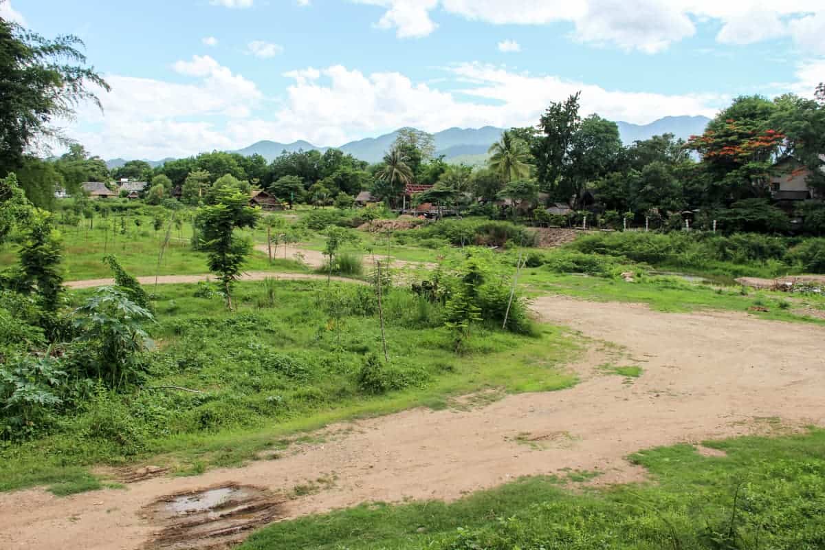 Rural road surrounded by forest on the journey from Getting from Chiang Mai to Pai in Thailand