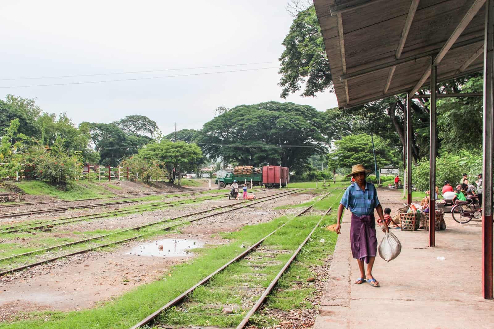 Local man walking on platform at Hsipaw train station in Myanmar