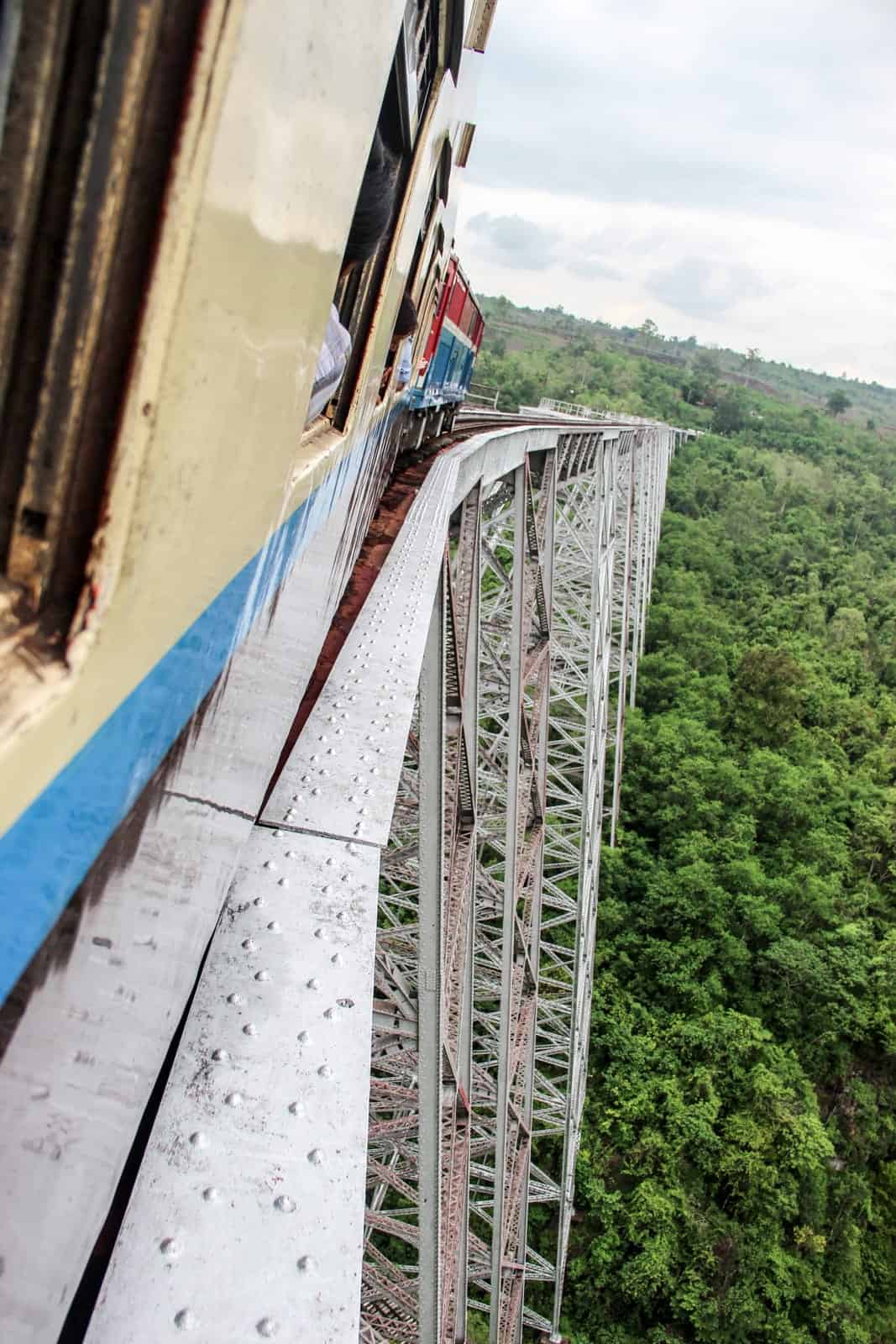 Riding across the high steel Goteik Viaduct bridge on the Myanmar railway. 