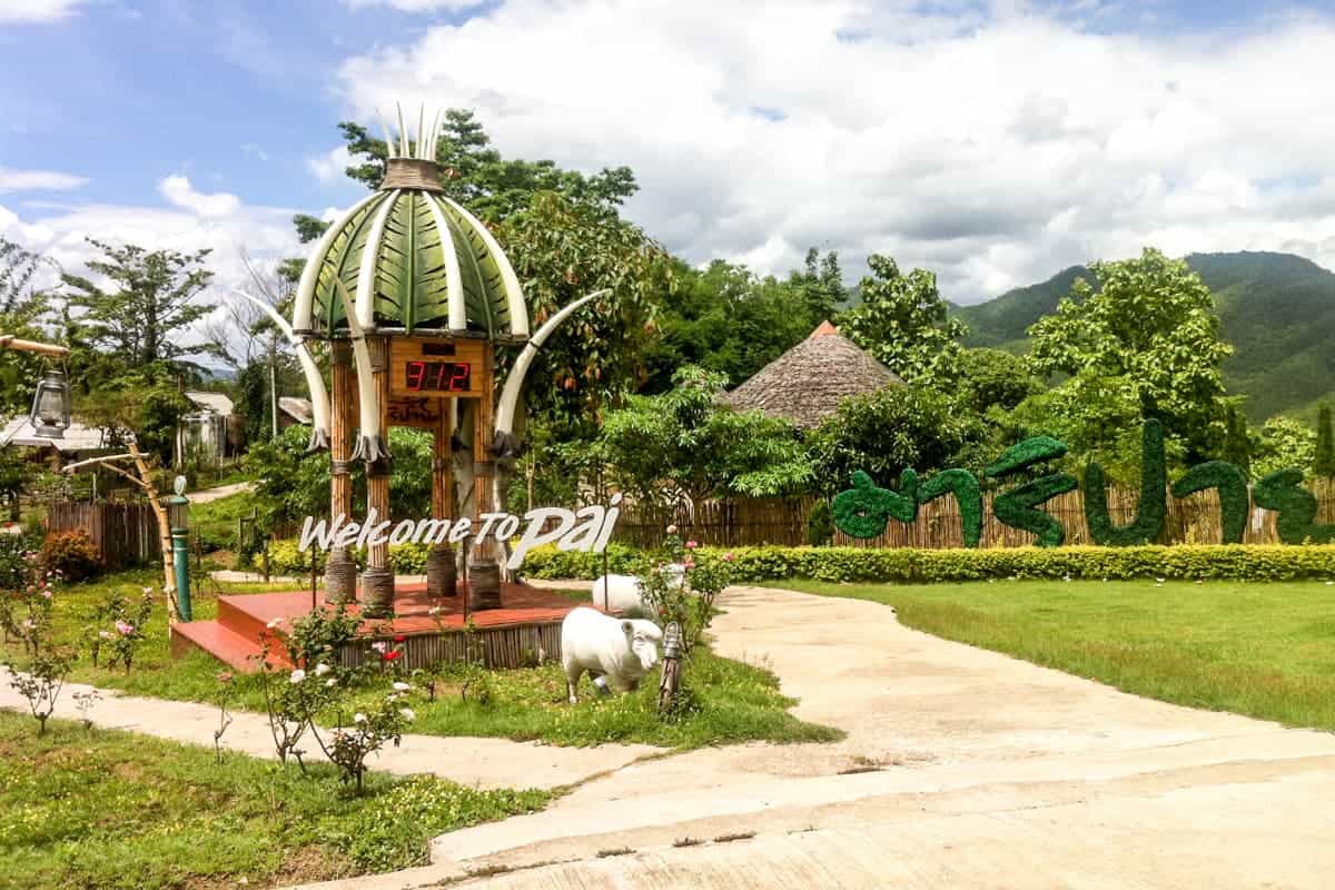 A vegetable themed 'Welcome to Pai' signage in a hilltop art garden.