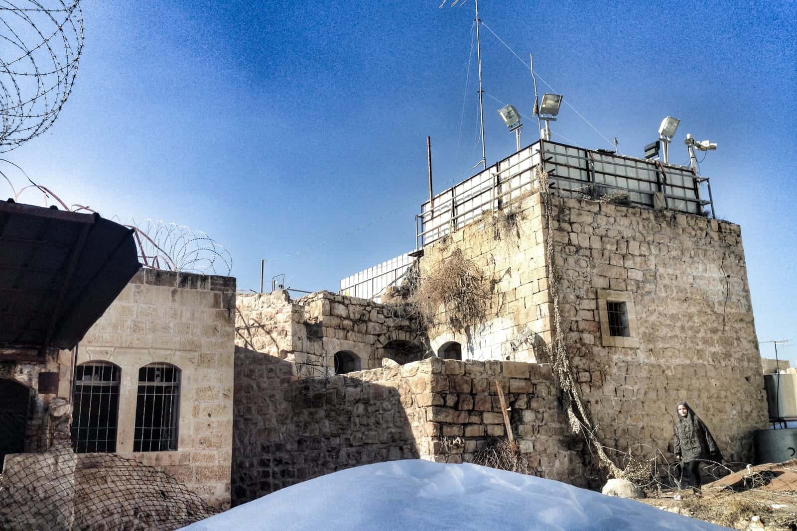 Israeli solider on Palestinian rooftop in Hebron in the West Bank, Palestine 