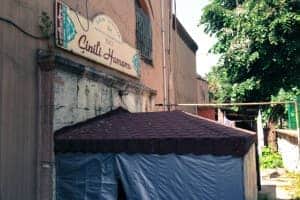 The exterior of a brick building with a sign for a Turkish Hamam bath.