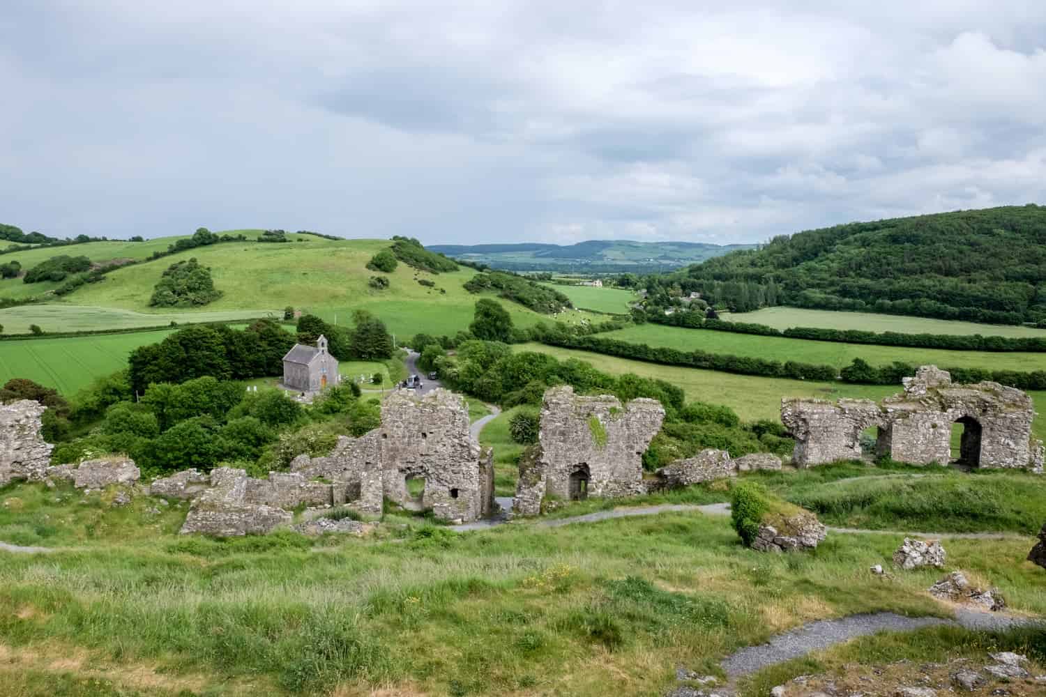 Ruins of the Rock of Dunamase on undulating green hills in Ireland