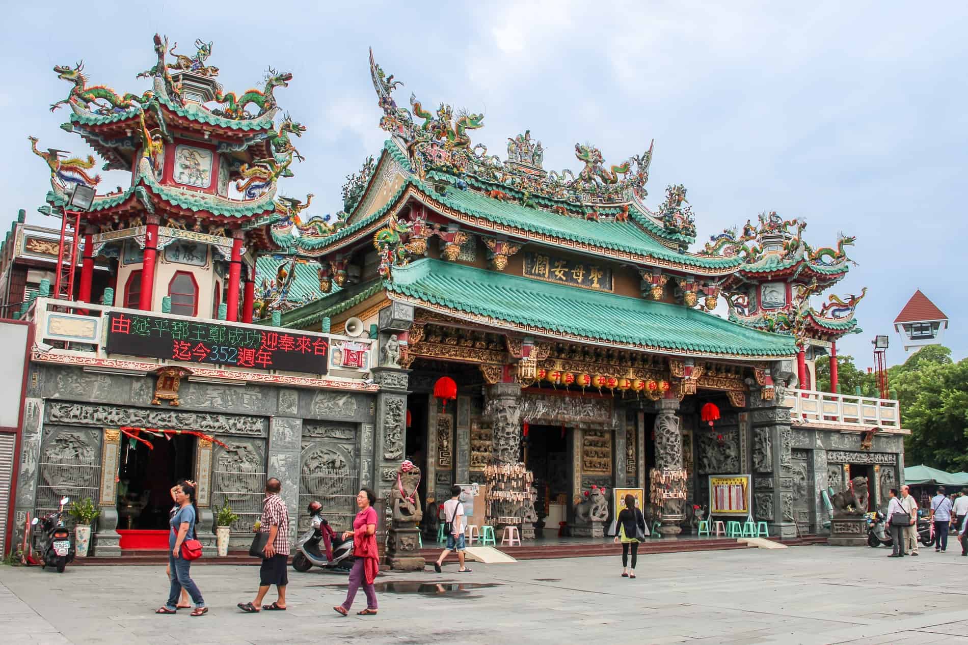 The intricate stone carvings, red columns and mint-green pagada roofs of the Anping Kaitai Tianhou Matsu Temple in Tainan. 