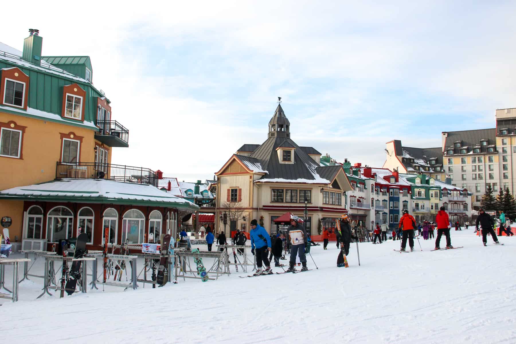 Skiers in the colourful Mont Tremblant pedestrian village in Quebec, Canada.