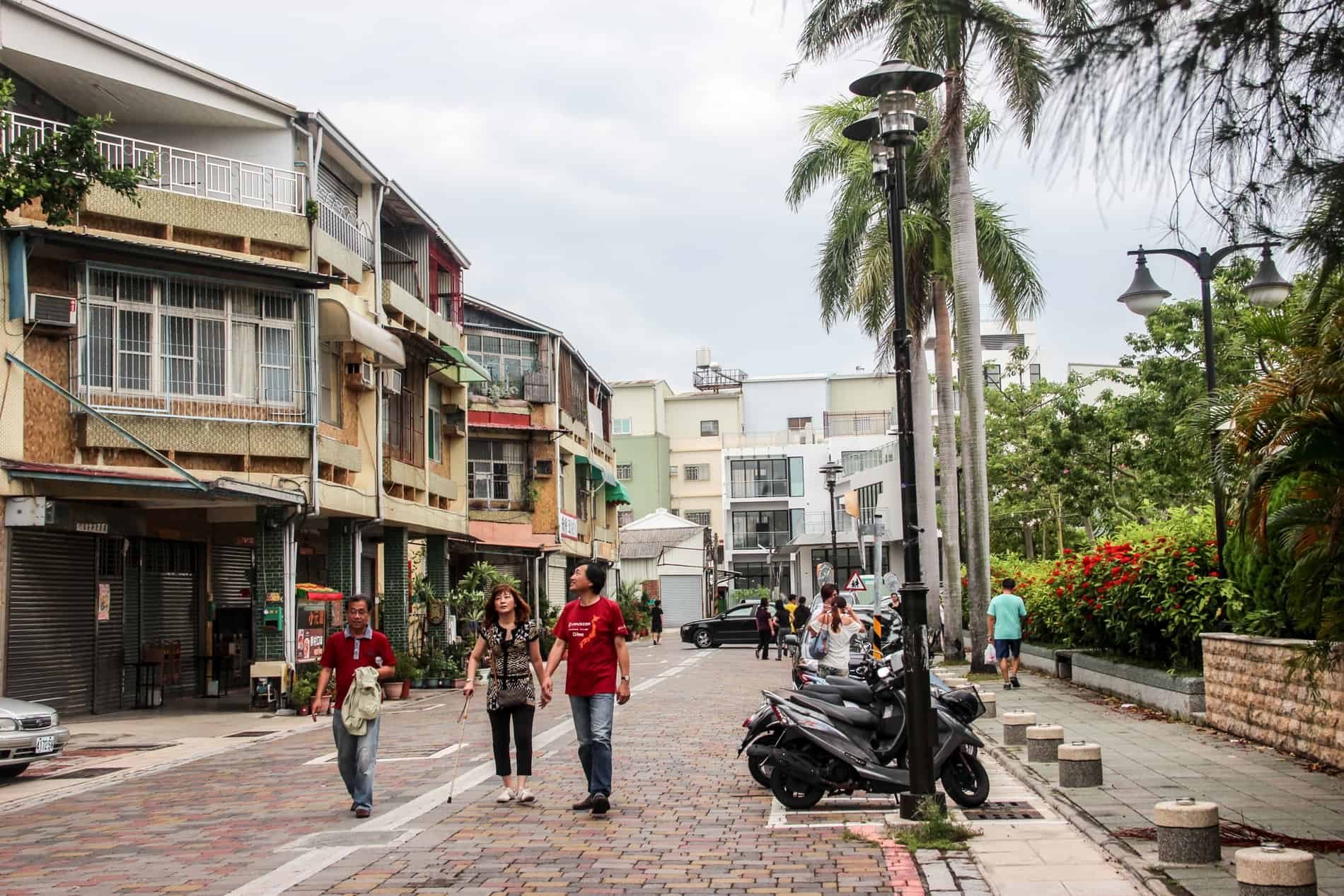 People walking down a residental street in the Anping District of Tainan city in Taiwan. 