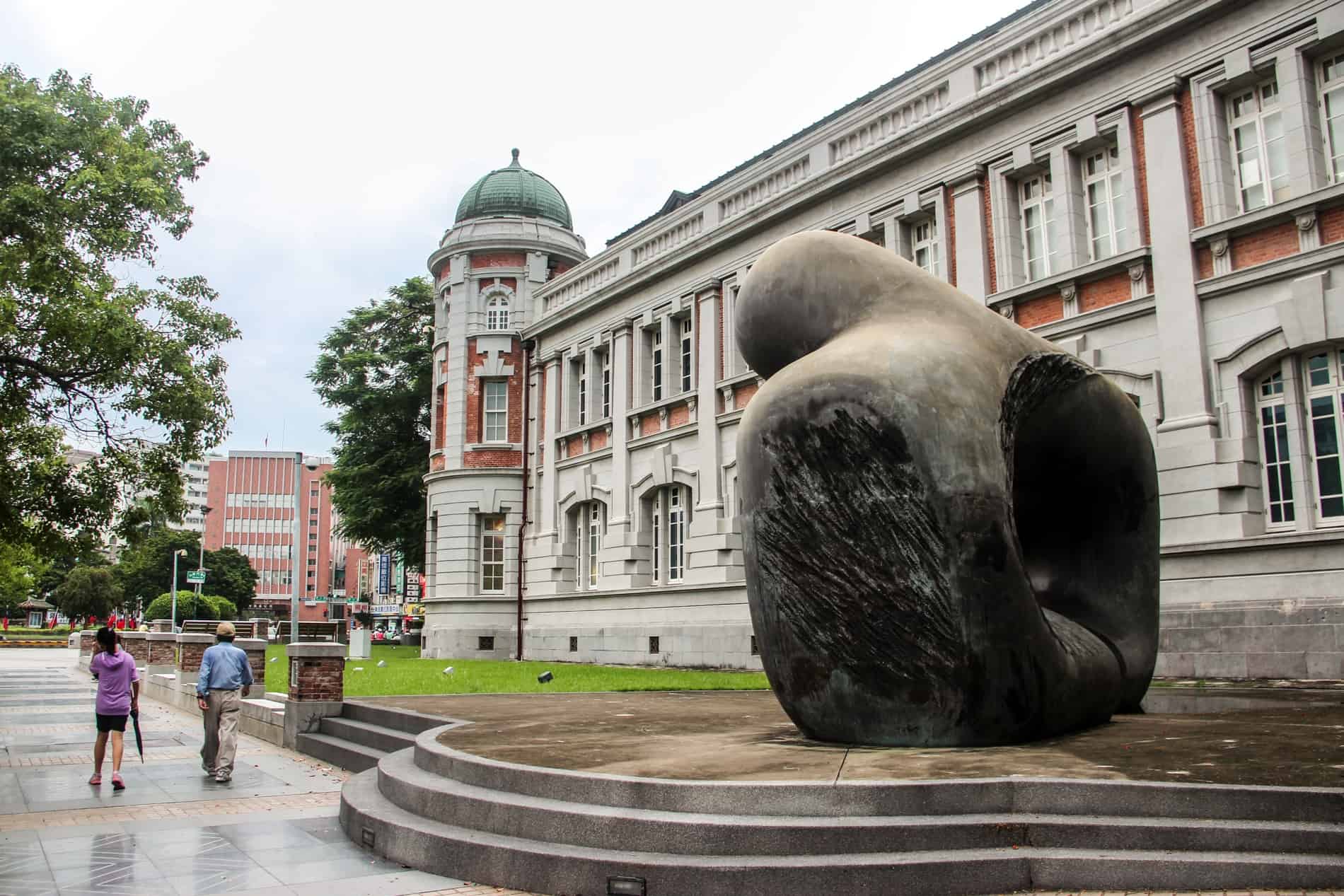 A bronze sculpture outside the colonial style Tainan City Council History Museum building.