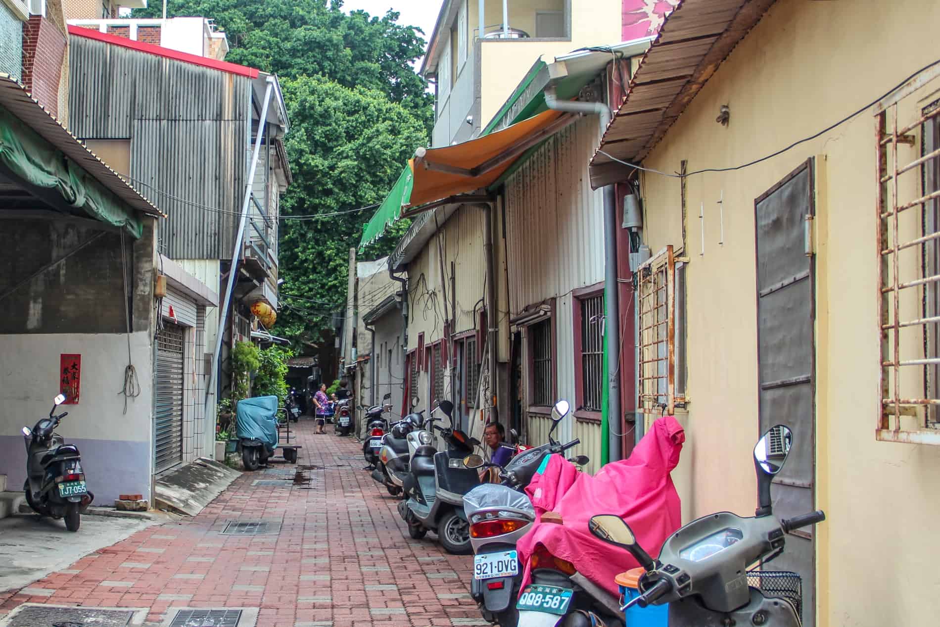 Locals outside thier homes on a narrow street in the historical Anping district of Tainan. 