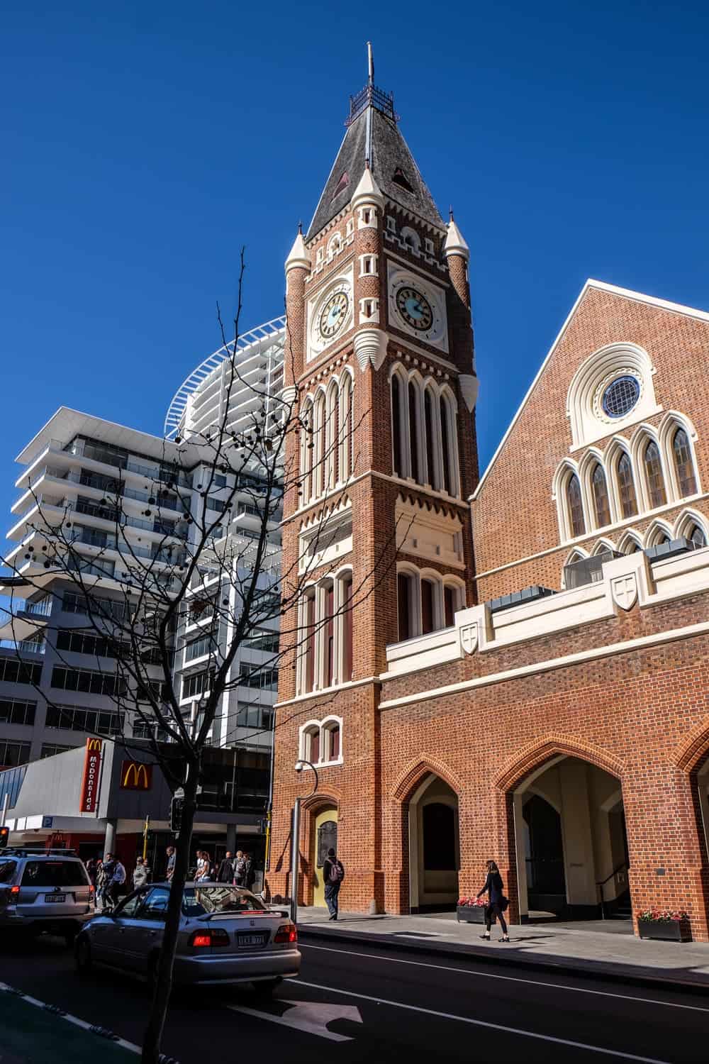 Older ochre brick buildings like this clock tower stand alongside modern, glass structures as part of Perth's regeneration