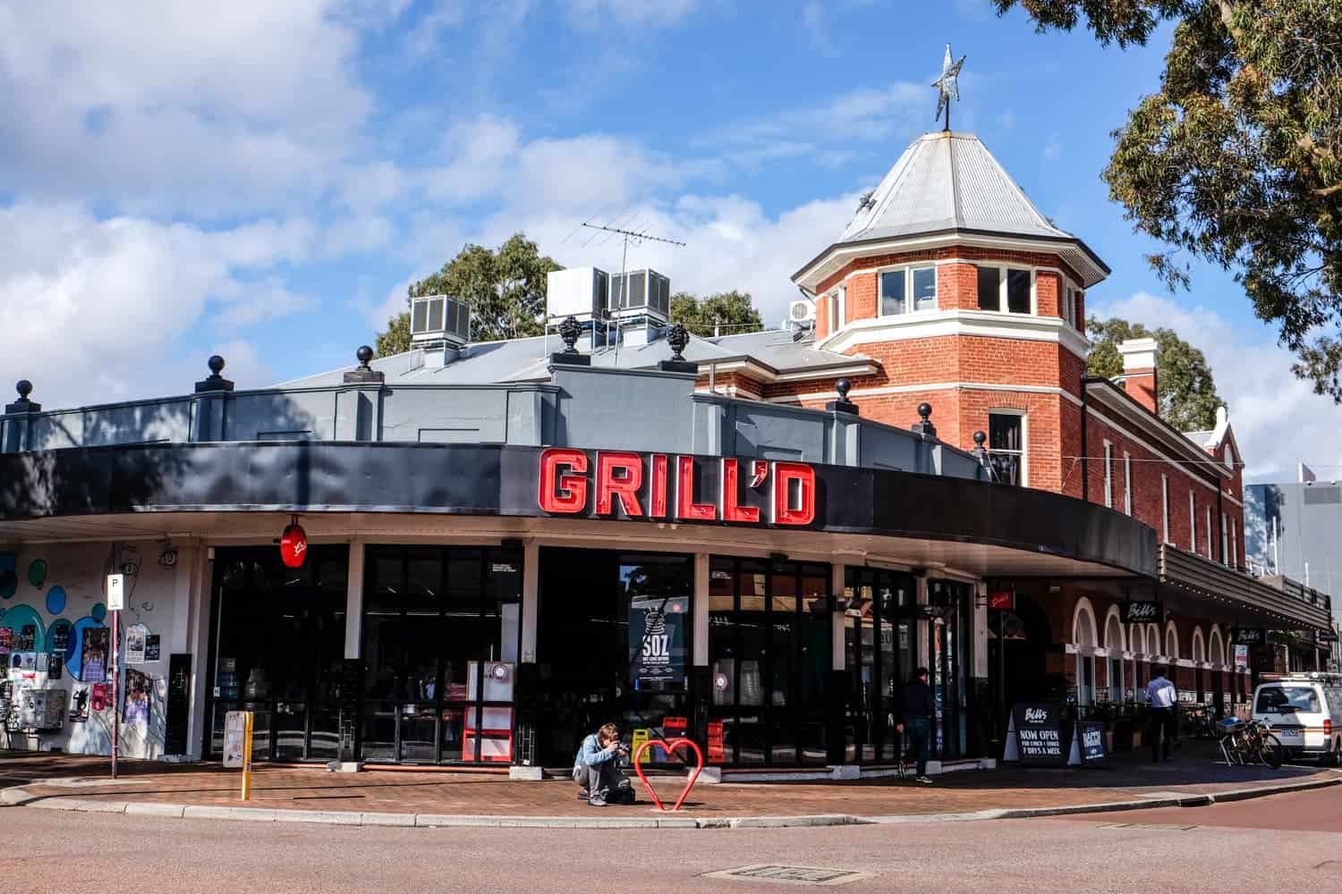 A modern restaurant exterior built into an old red brick building in Perth