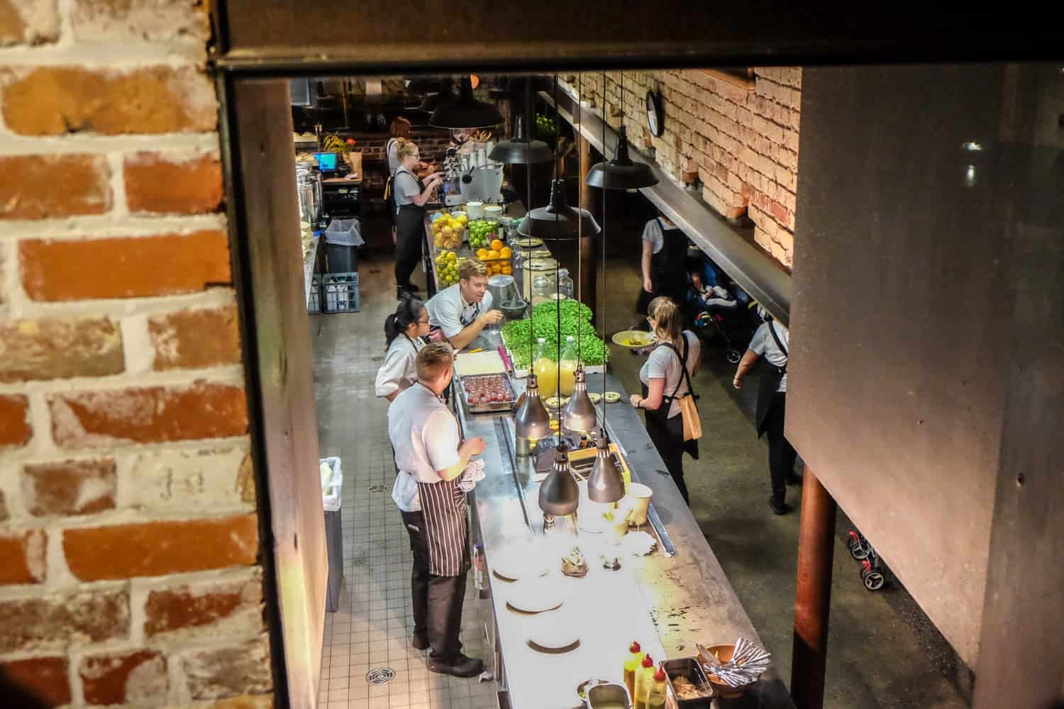 Chefs prepare food in the restaurant that was a former warehouse in Perth