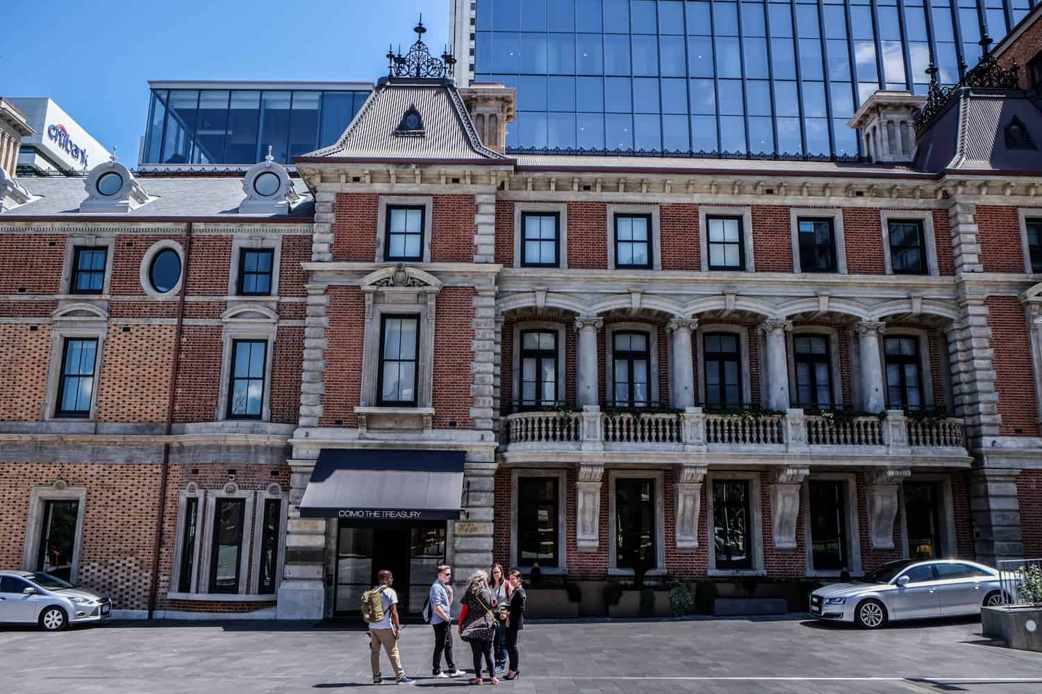 The brick exterior of one of Perth's State Buildings, with tall windows broken up by columns