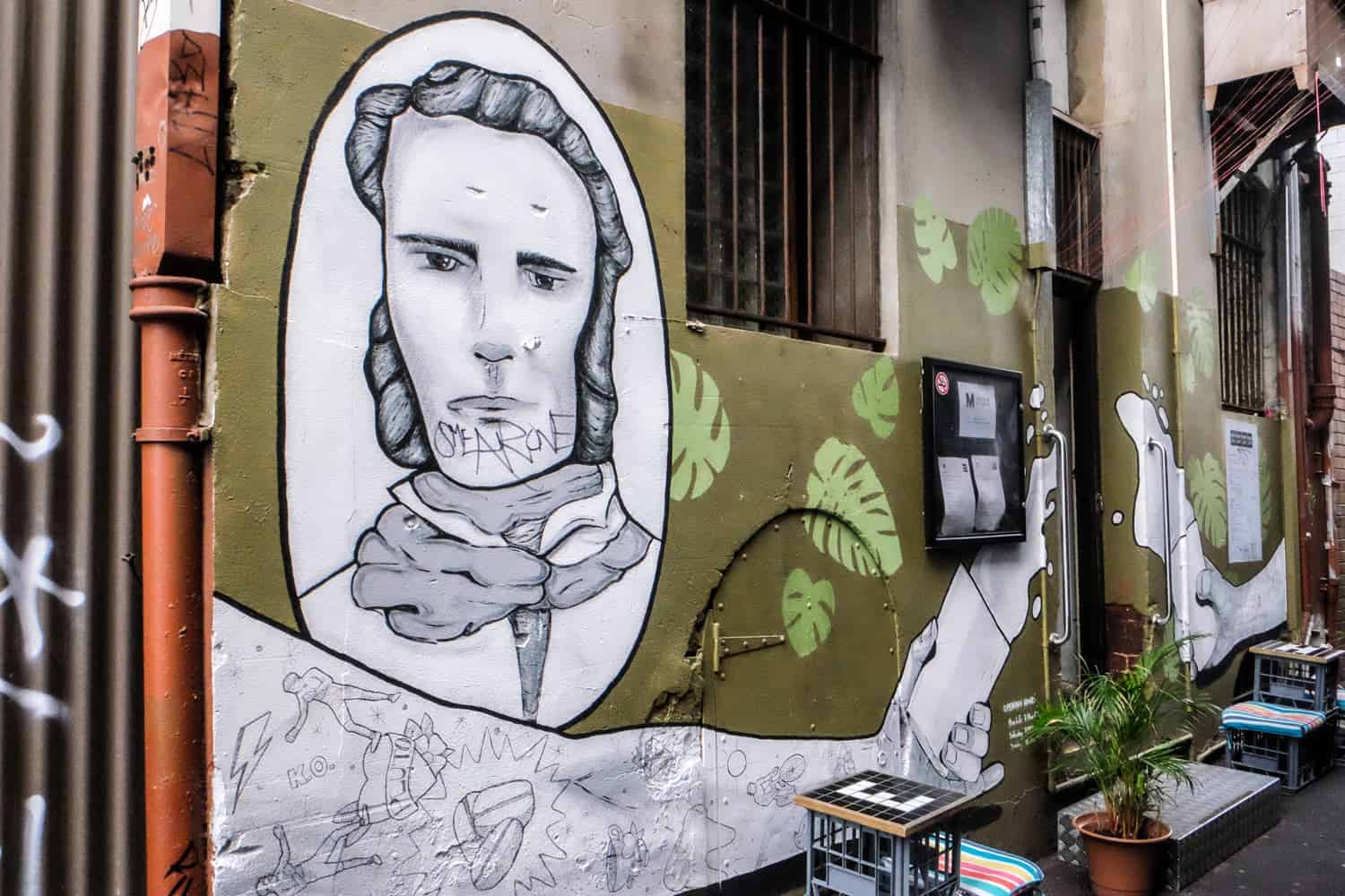 Arte callejero en la pared de un café en los callejones escondidos de Perth, Australia
