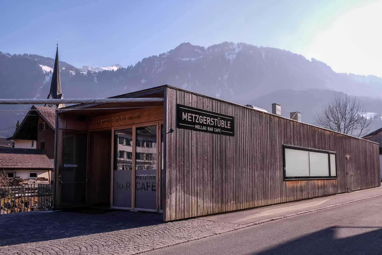 A slick,modern wooden building design blends in a traditional alpine village in Bregenzerwald, Vorarlberg