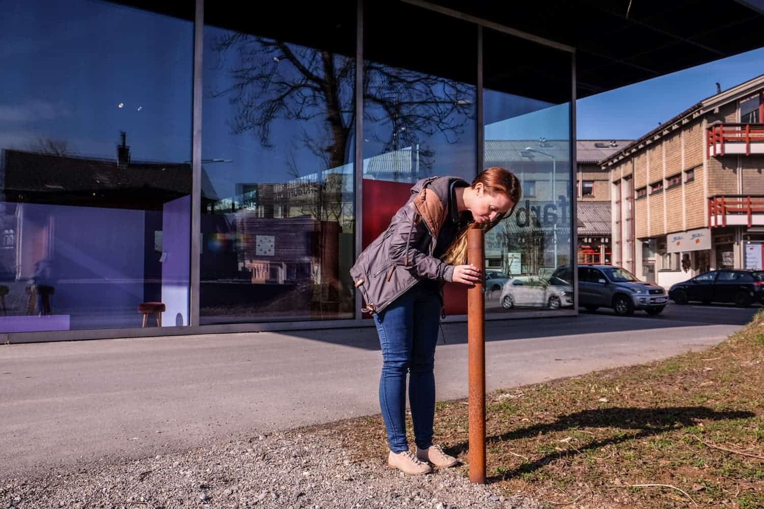 Red information columns at buildings on the architecture trail in Vorarlberg, Austria