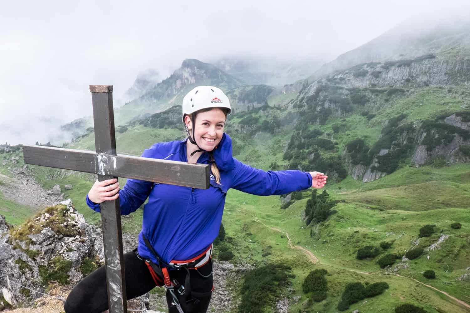 Reaching a summit cross on the Achensee 5-Peaks Via Ferrata in the Rofan Mountains, Tirol