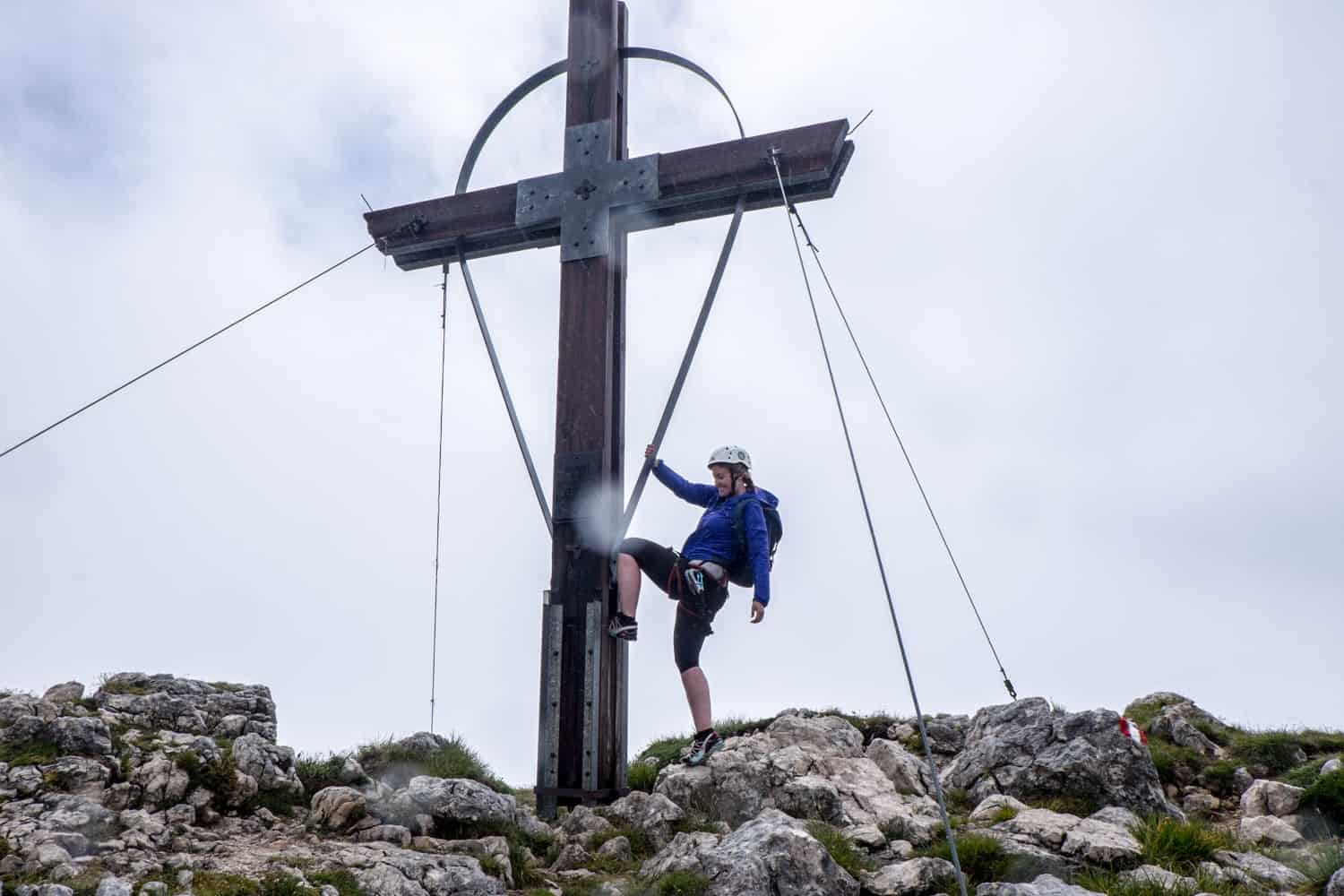 Reaching the summit cross on the Achensee 5-Peaks Via Ferrata in the Rofan Mountains, Tirol