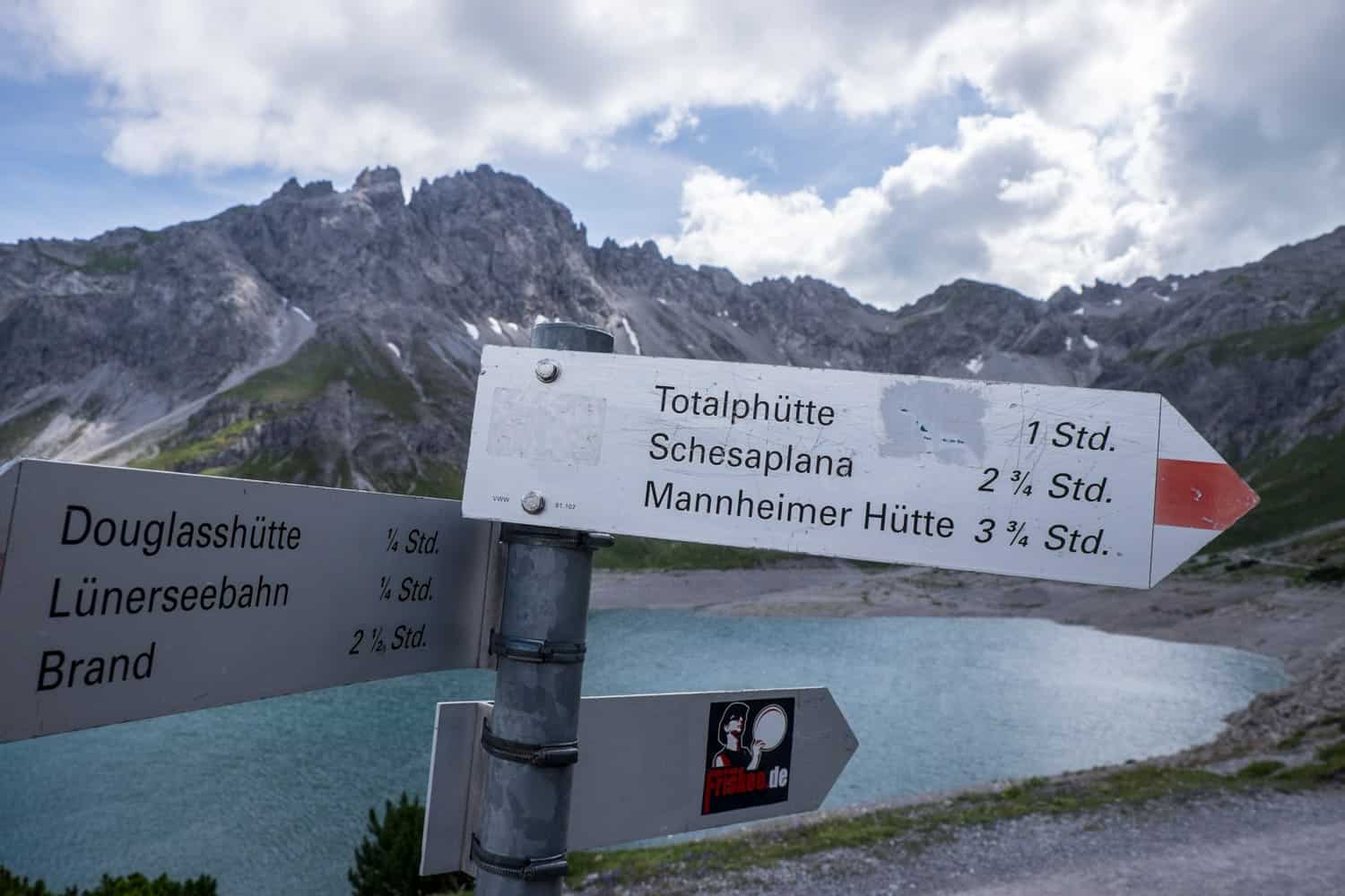 Signs for hiking oaths and huts a Lake Lunersee in Vorarlberg, Austria