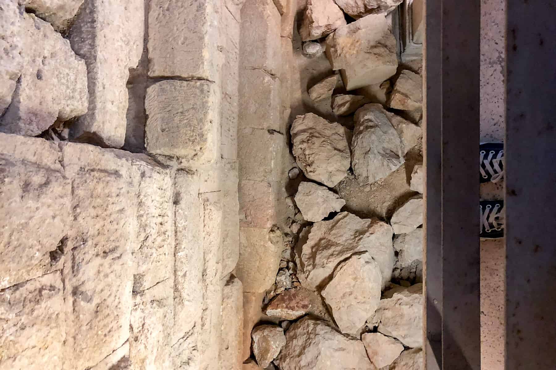 An elevated view of the old stone of the former city wall of Roman Tarraco, next to the newer wall (on the left) of today's Tarragona Cathedral