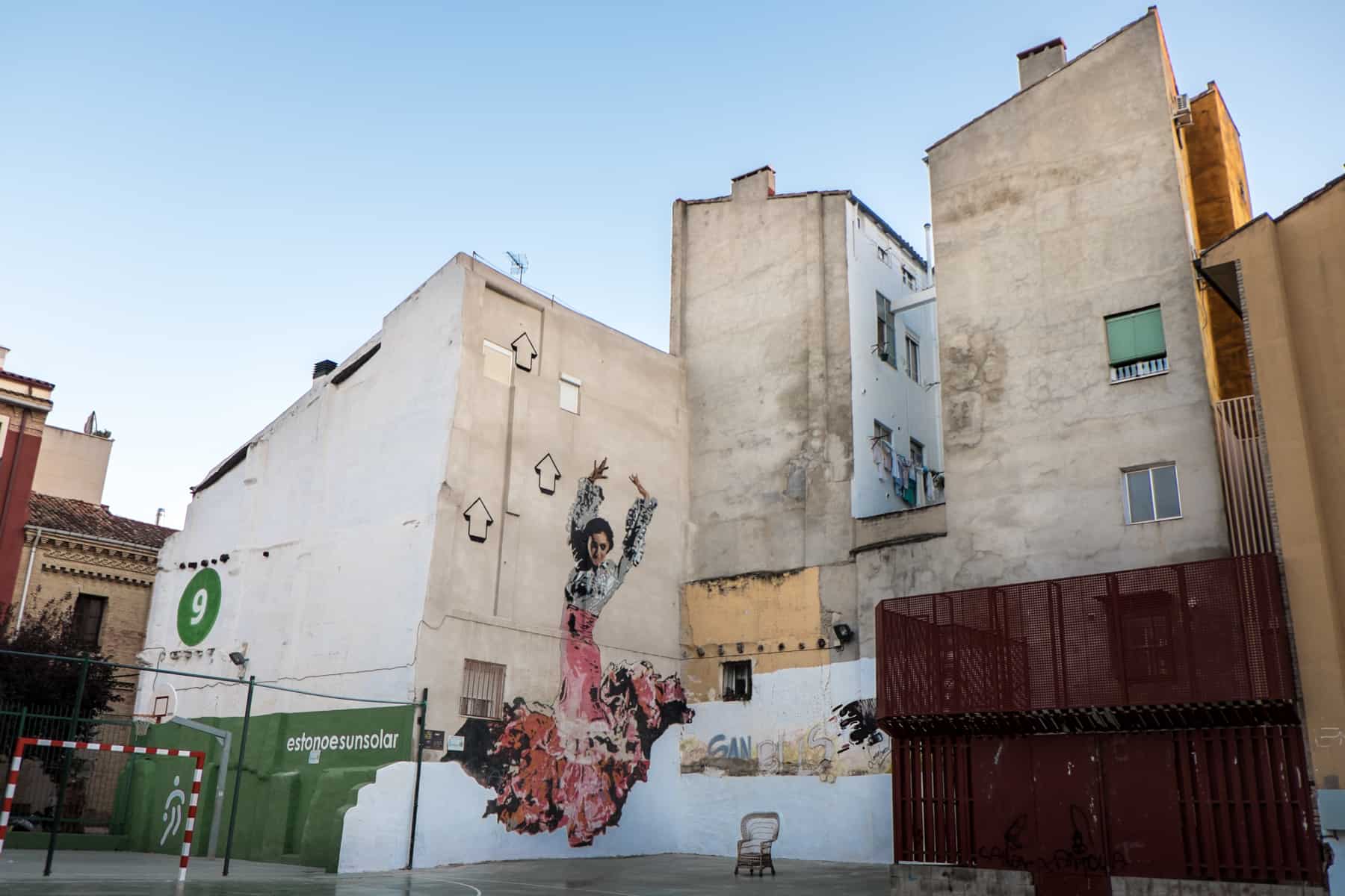 Zaragoza's street art collection includes a Flamenco dancer on a building in a neighbourhood sports court. 