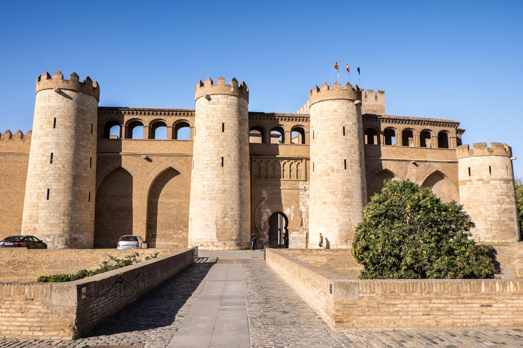 The golden stone, four-pillar castle-like Ajafería Palace in Zaragoza, Spain. 