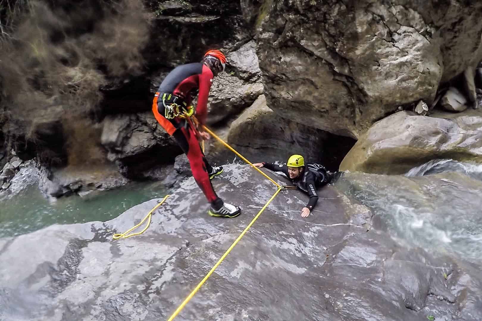 Sliding down large rocks canyoning in Vorarlberg, Austria