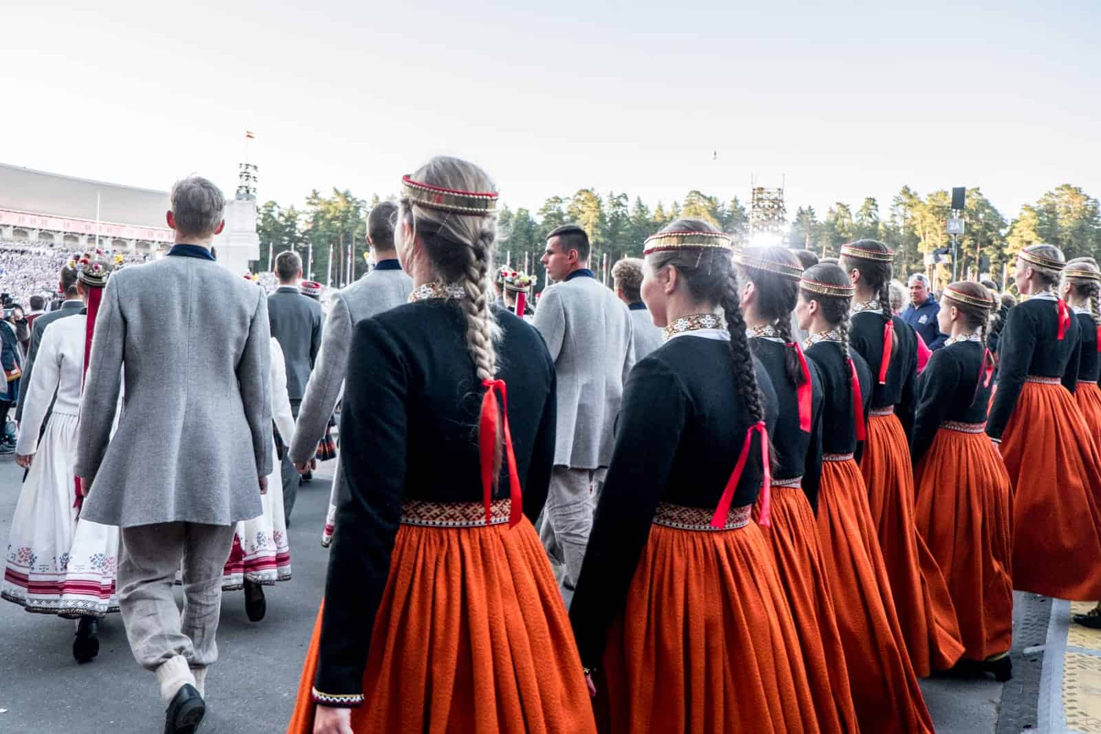 Choir singers wait to enter the stage at the Closing show of the Latvia Song and Dance Celebration