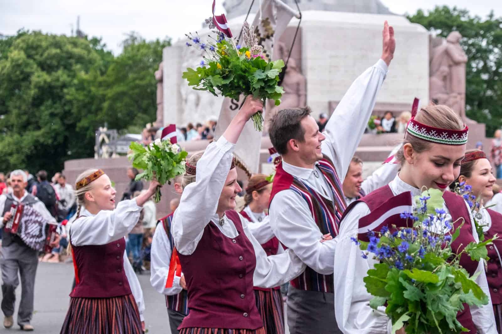 People cheer at the Latvia Song Dance Celebration in Riga