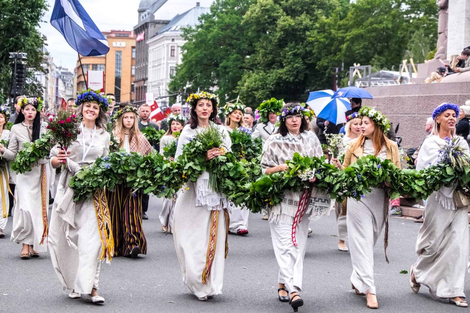 Women with flowers at the Song and Dance Celebration in Riga, Latvia