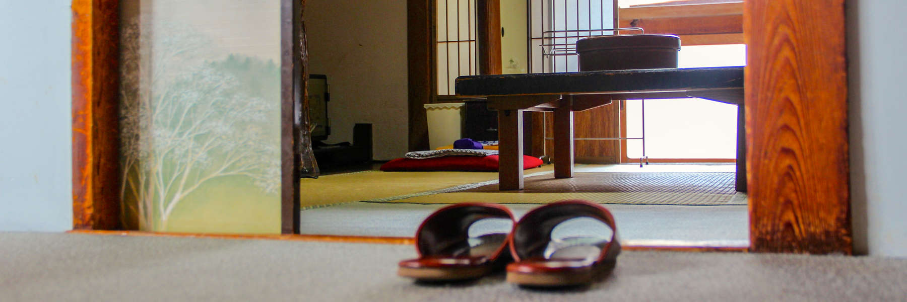 A pair of brown house slippers left outside the entrance to a room in a Japanese Ryokan.