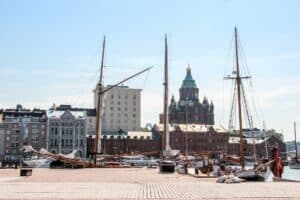 Kauppatori Market Square in Helsinki, with sail boats docked in the harbour, and low rise buildings behind.