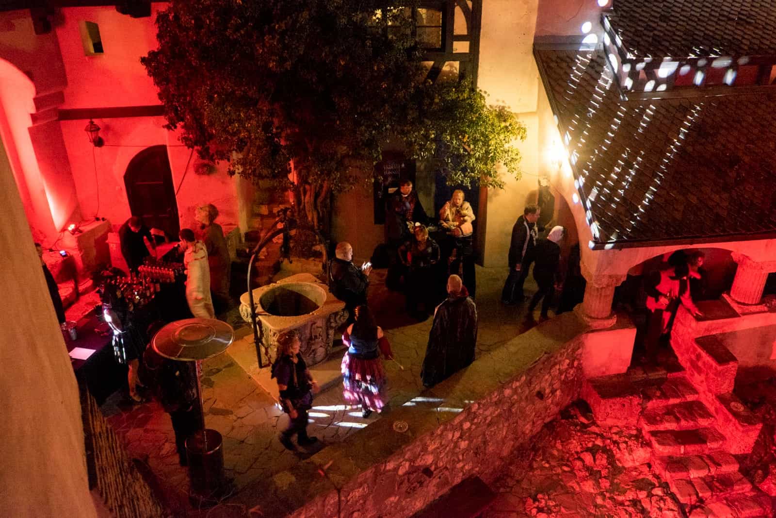 A group of people in Halloween costume party in a courtyard in Bran Castle, Transylvania, Romania