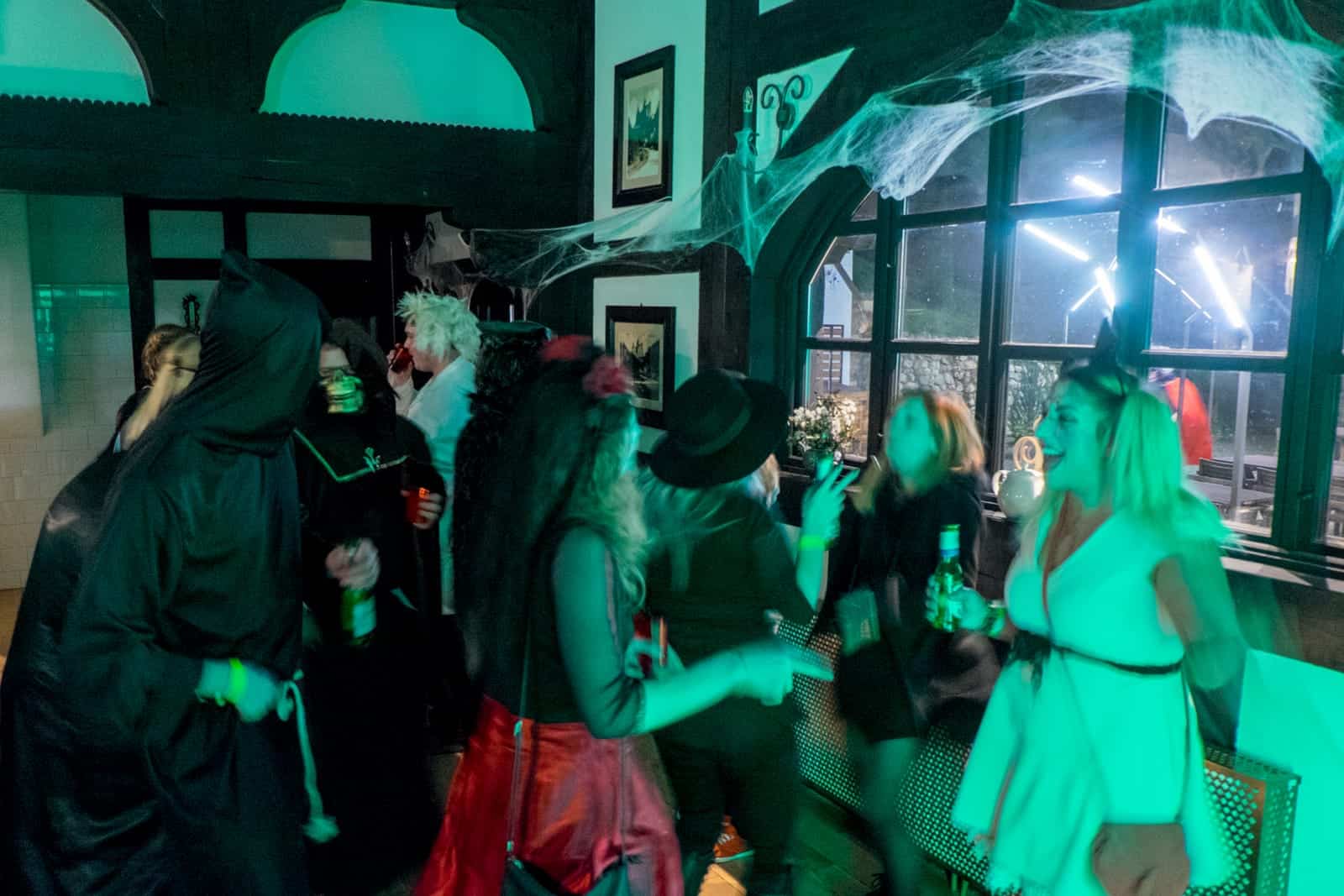 Eight people in costume at a Halloween party in Bran Castle, Transylvania, Romania