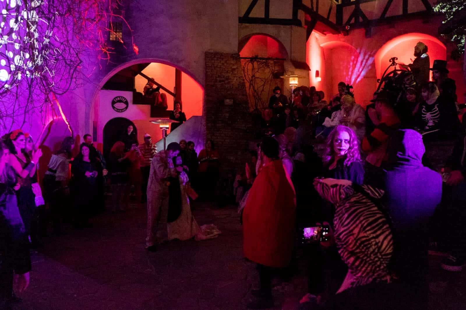 A group of people in costume at a Halloween party in Bran Castle, Transylvania, Romania