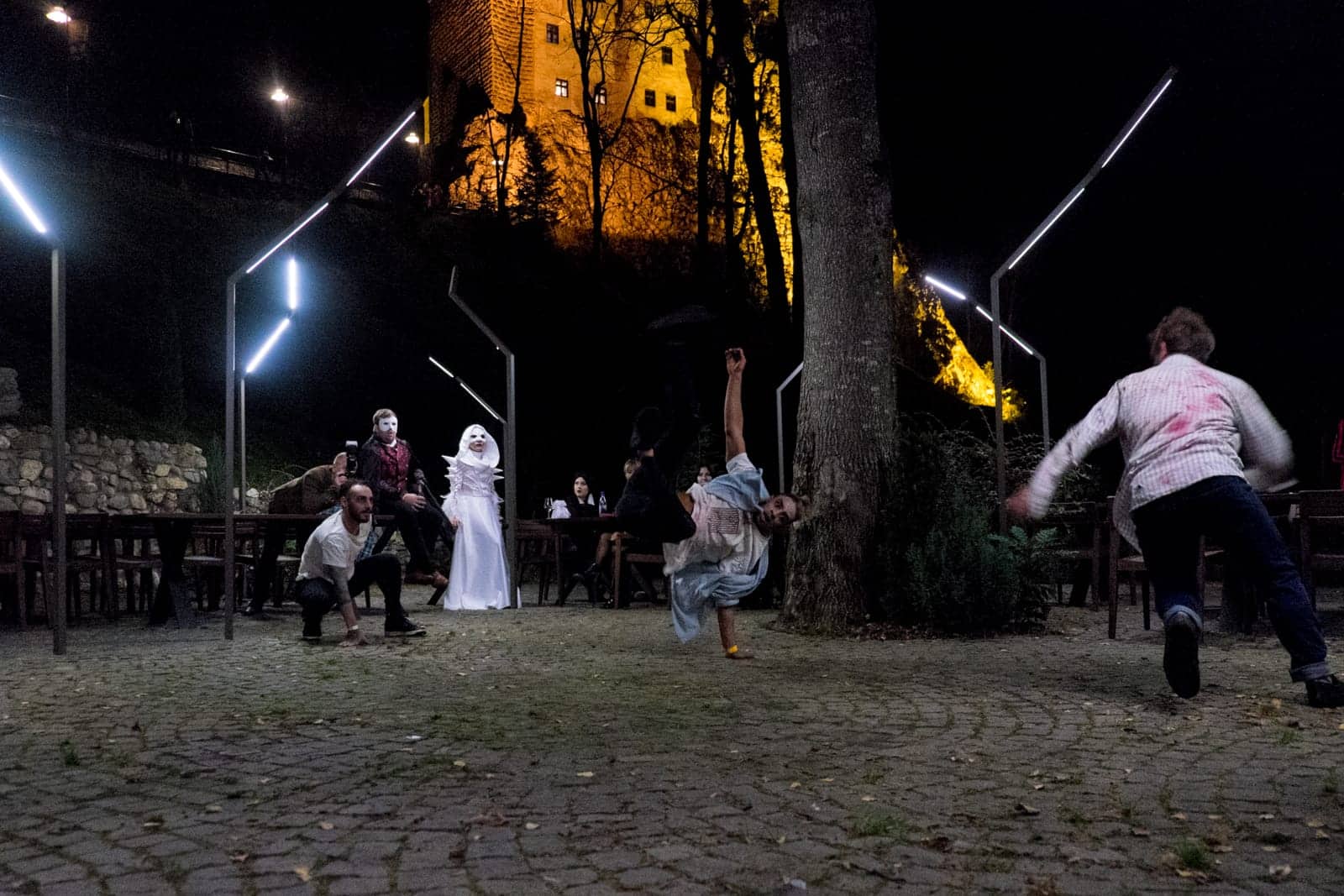 Two breakdancers in costume perform at a Halloween party in the grounds of Bran Castle, Transylvania, Romania