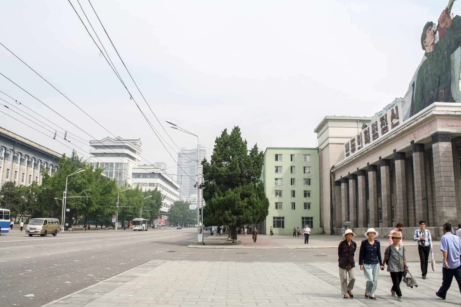 A street in Pyongyang with locals walking - what you see from the bus window on a North Korean tour