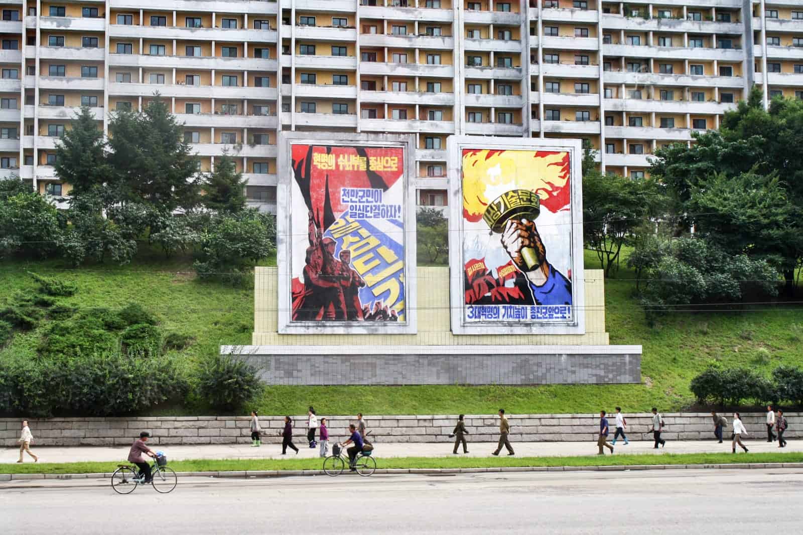 Propaganda poster in Pyongyang, North Korea as seen from the bus on a North Korea tour