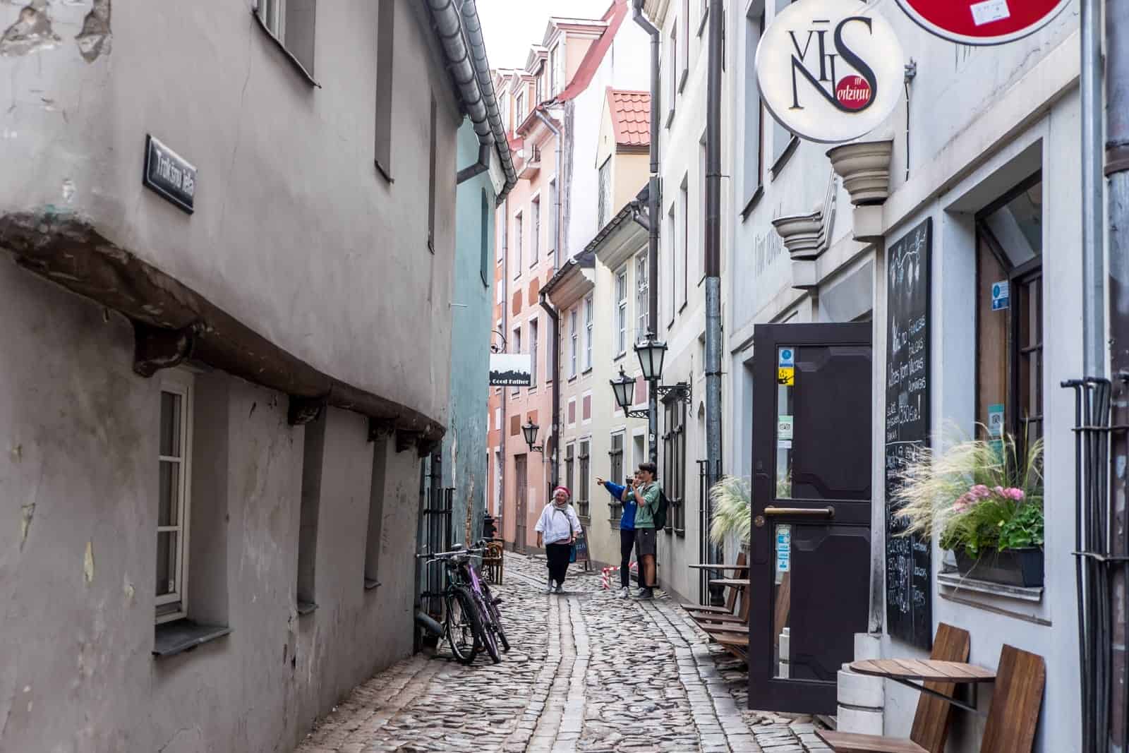 Narrow medieval street in Riga Old Town lined with shops