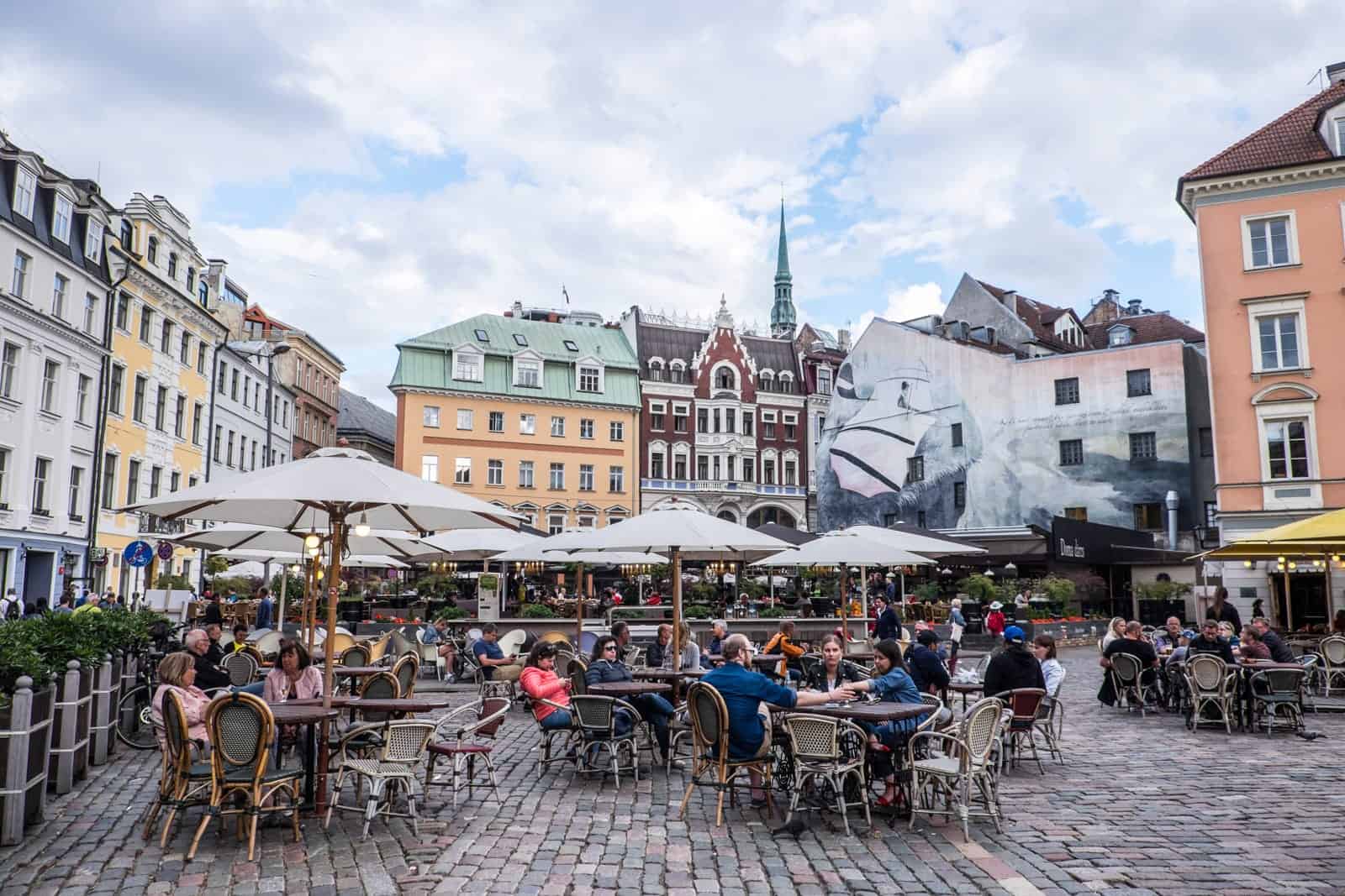 The main square of Riga Old Town where people dine outside 