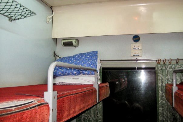 View of the top bunk bed in a basic private cabin on a Vietnam train.
