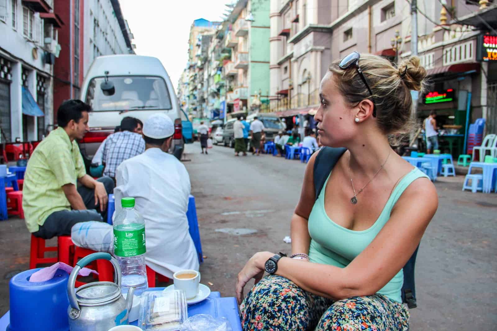 Tourist in Myanmar spending money on street food for budget travel