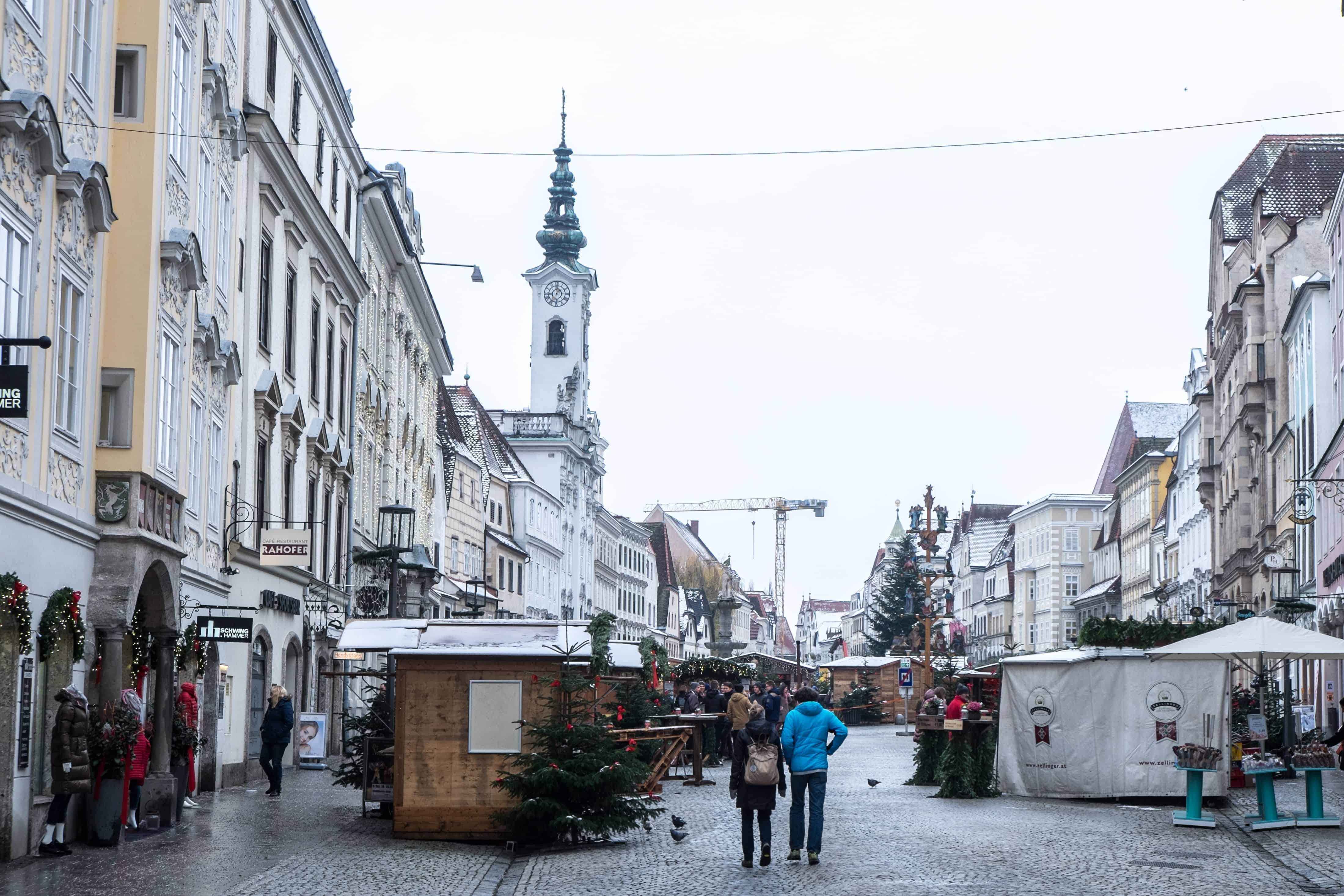 Steyr Austria Christmas Market Stalls between rows of classic pastel buildings. 