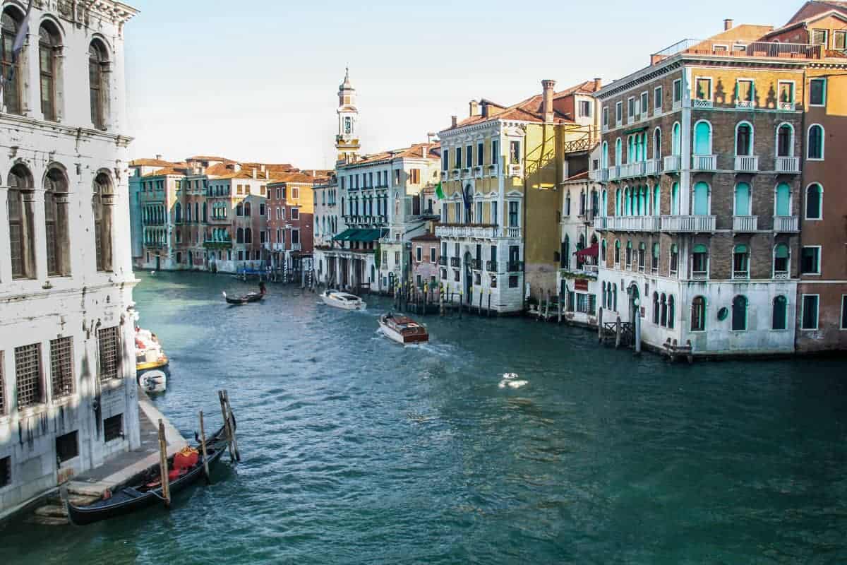 Views from a bridge over the Grand Canal in Venice where boats and gondolas pass