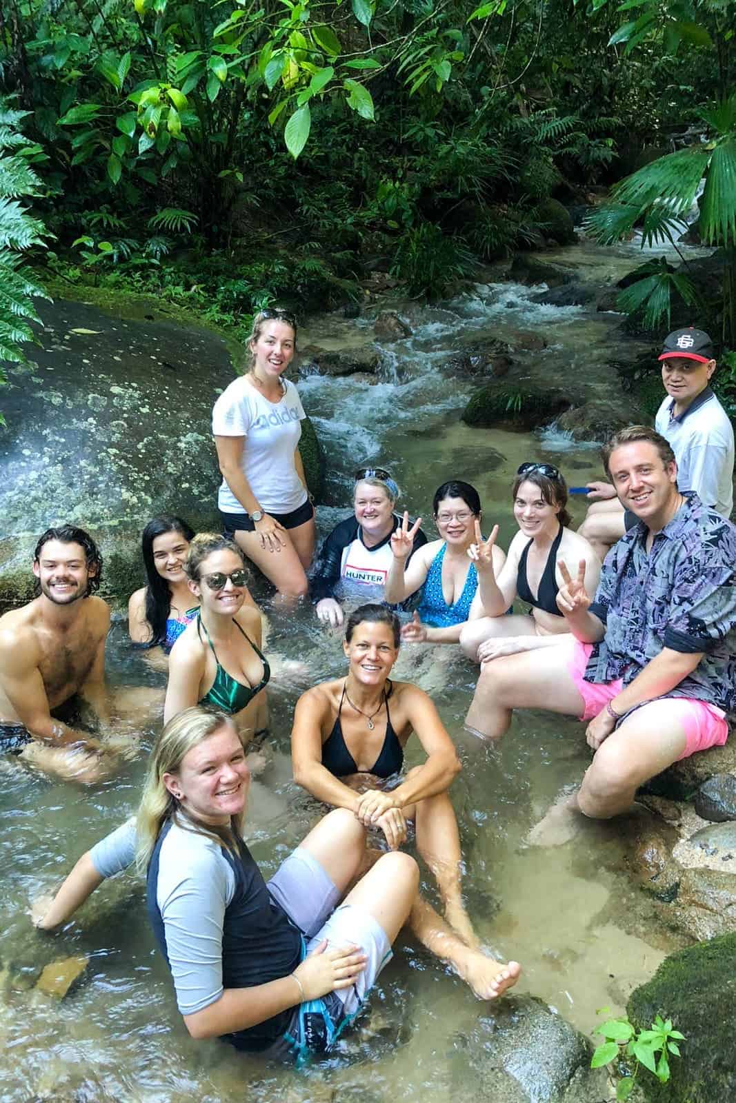 A group of people jungle stream bathing in Ecuador Amazon.